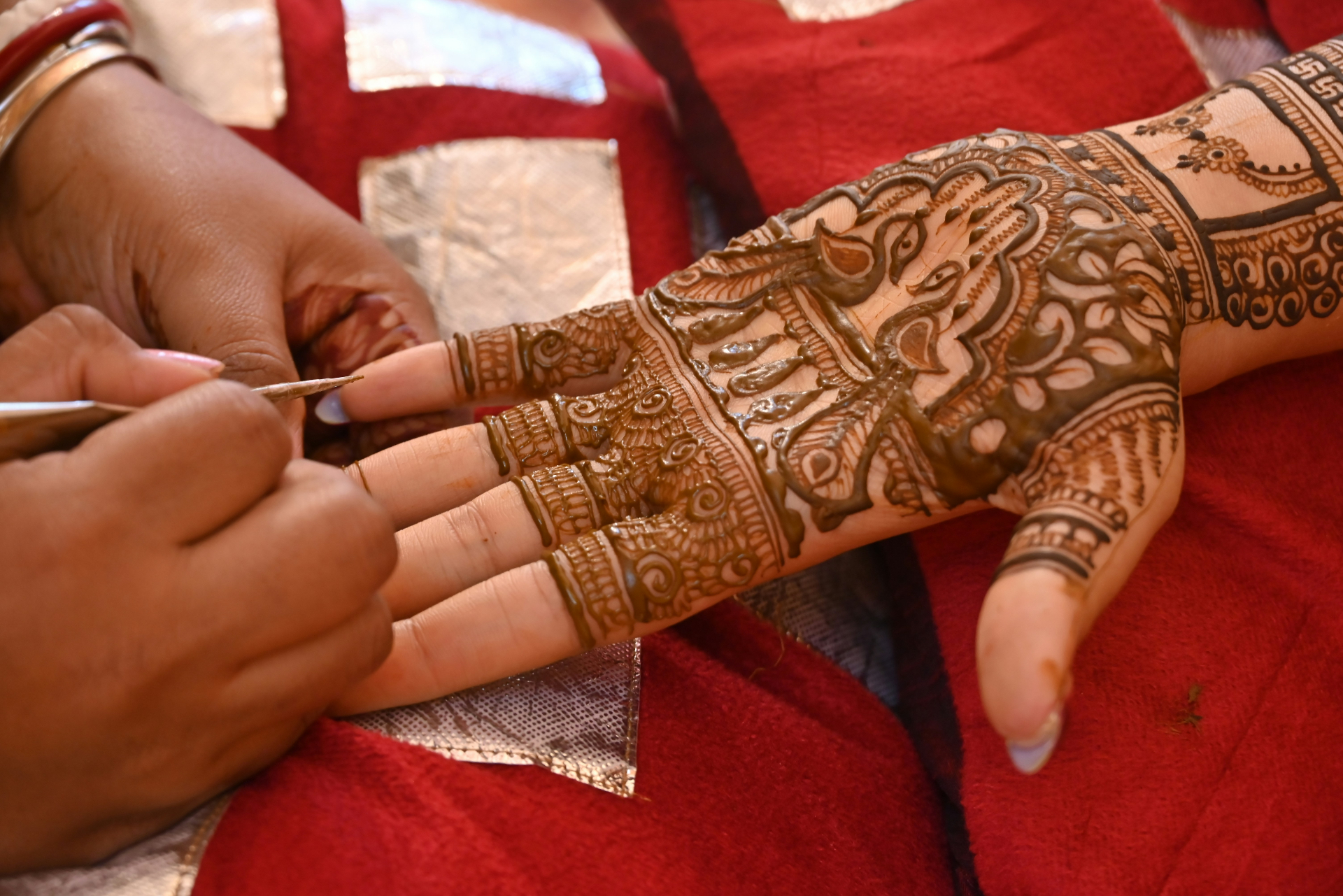 Bridal henna being applied